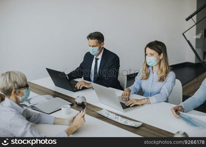 Group of business people with young adults and senior woman colleague on meeting at the modern bright office interior