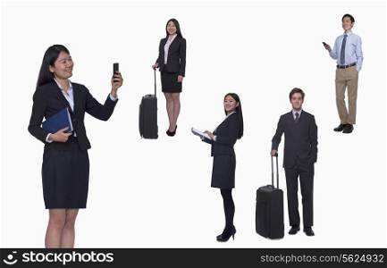 Group of business people working, taking photos, texting, studio shot, full length