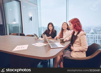 Group of business women meeting in a meeting room with blank scr. Group of business women meeting in a meeting room with blank screen, sharing their ideas, Multi ethnic. Group of business women meeting in a meeting room with blank screen, sharing their ideas, Multi ethnic