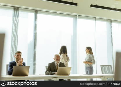 Group of businessmen and businesswomen working together in office