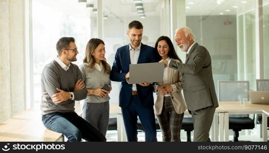 Group of businessmen and businesswomen working together in office