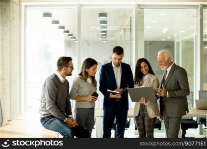 Group of businessmen and businesswomen working together in office