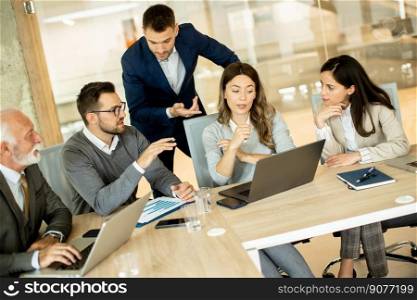 Group of businessmen and businesswomen working together in office