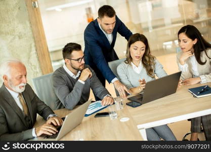 Group of businessmen and businesswomen working together in office