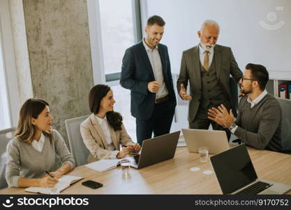 Group of businessmen and businesswomen working together in office