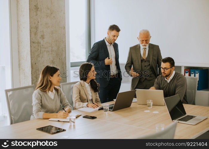 Group of businessmen and businesswomen working together in office