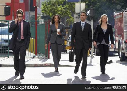 Group Of Businesspeople Crossing Street