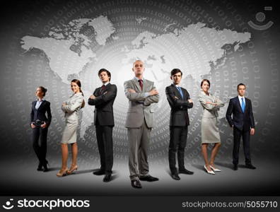 Group of businesspeople. Image of businesspeople standing against world map background