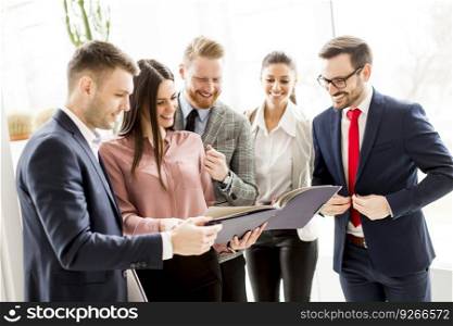 Group of businesspeople standing in the modern  bright office