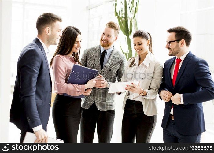 Group of businesspeople standing in the modern  bright office