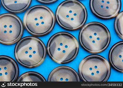 group of buttons with four holes on a blue background