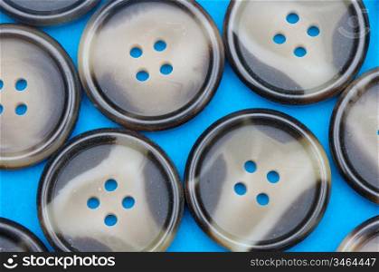 group of buttons with four holes on a blue background