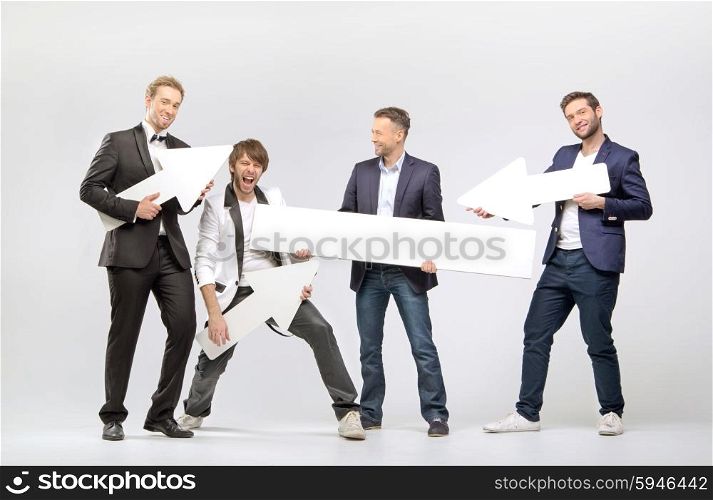 Group of cheerful men with arrows and boards