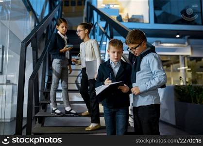 Group of children businesspeople talking on staircase. Great ideas come from casual conversation. Group of children businesspeople talking on staircase
