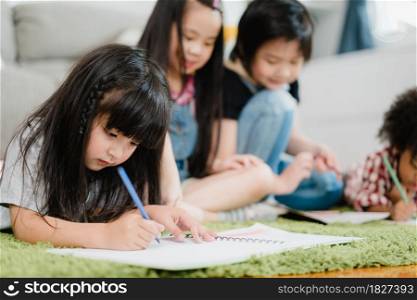 Group of children drawing in classroom, Multi-ethnic young boys and girls happy funny study and play painting on paper at elementary school. Kids drawing and painting at school concept.