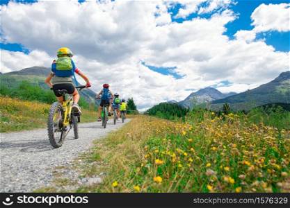 Group of children during a bike ride in the mountains.