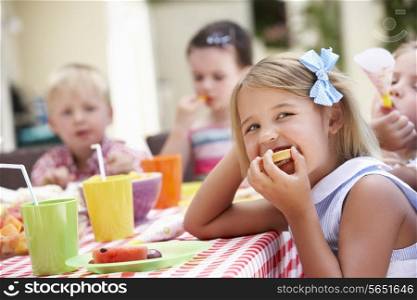 Group Of Children Enjoying Outdoor Tea Party