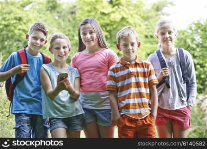 Group Of Children Geocaching In Woods