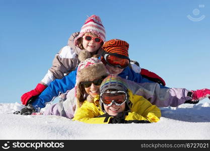 Group Of Children Having Fun On Ski Holiday In Mountains