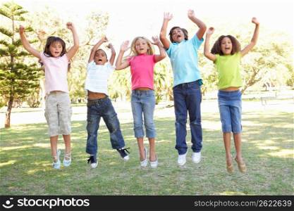 Group Of Children Jumping In Air In Park