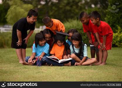 Group of children lying reading on grass field