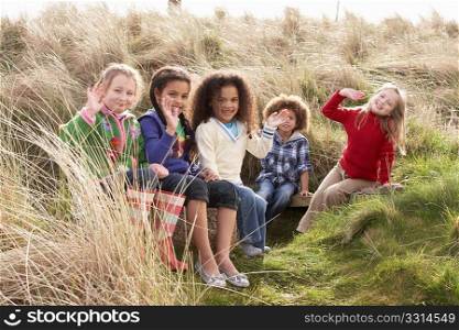 Group Of Children Playing In Field Together