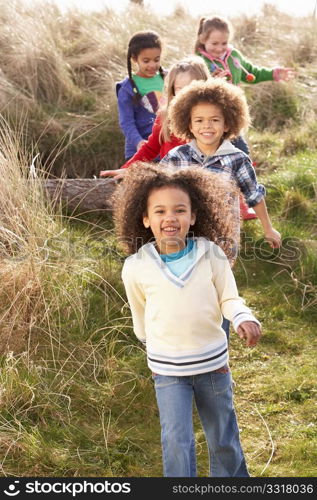 Group Of Children Playing In Field Together