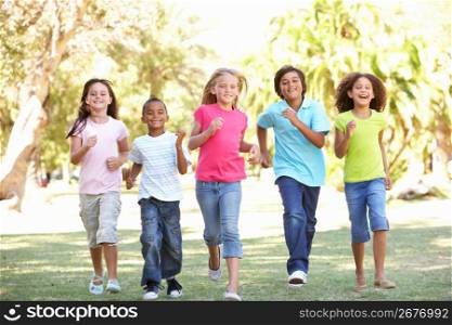 Group Of Children Running Through Park