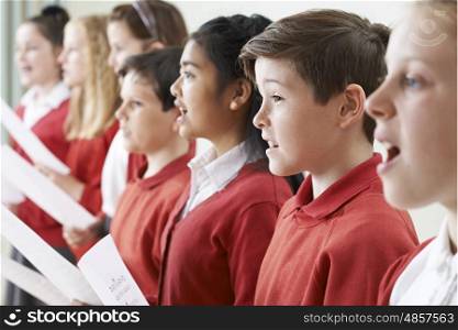 Group Of Children Singing In School Choir