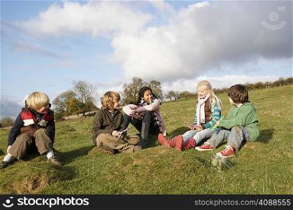 Group of children sitting on hill