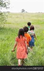 Group of Children Walking Across Meadow