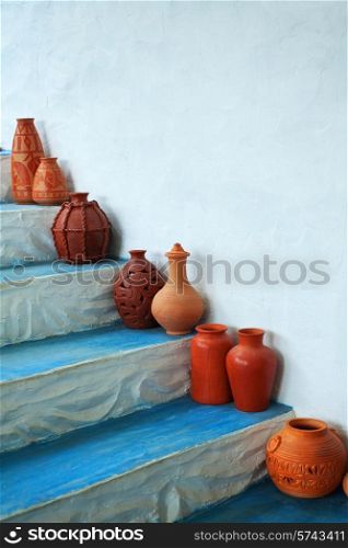 Group of clay jugs on the steps of the house