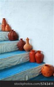 Group of clay jugs on the steps of the house