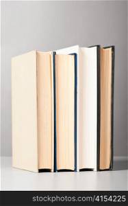 group of closed books on gray background