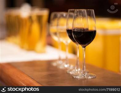 group of cold beer glass and wine on bar counter and free space for your decoration.