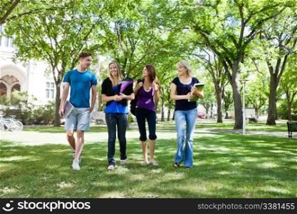 Group of college students walking in campus ground