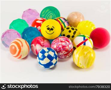 group of colorful bouncing rubber balls over white background