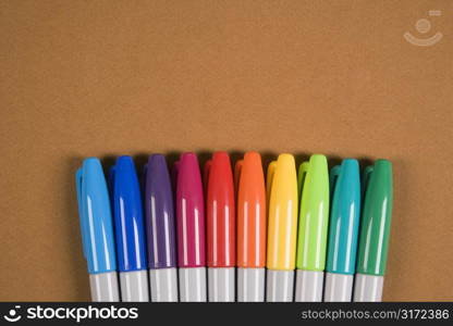 Group of colorful markers lined up in a row.
