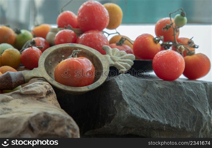 Group of Colorful variety of Fresh wild tomatoes (Mini Cherry Tomatos) on old wooden board background. Selective focus.