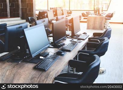 Group of computer with monitor neatly placed in a computer lab, computer room in the office modern with windows