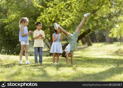 Group of cute asian and caucasian kids having fun in the park