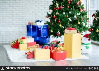 Group of decoration for Christmas festival including the present or gift box, snow man model, Christmas tree and other are set in room with glass window.