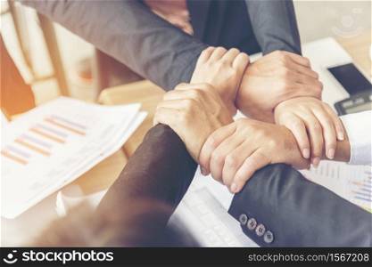 Group of diversity people with success partnership fist bump of hands together to show power and unified teams in office. Business teamwork trust in partner. Teamwork Concept.