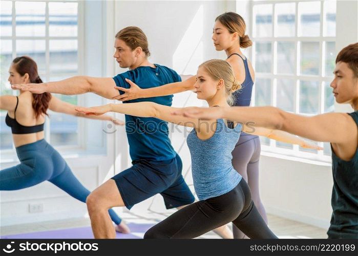 Group of diversity yoga sport people practice with their Coaching in yoga class, Asian Yoga instructor woman support young asian sport man for yoga training