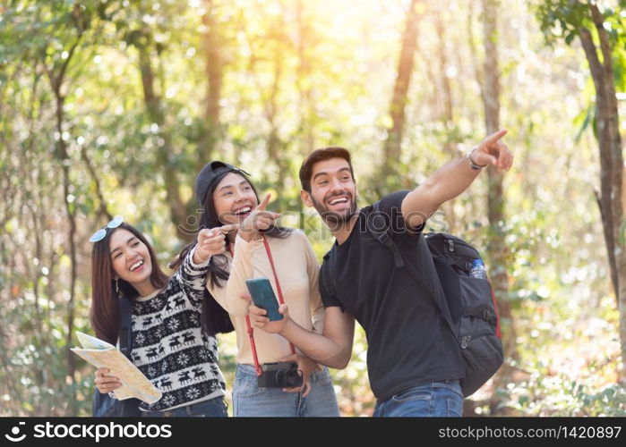Group of Diversity Young Tourists with Backpacks over nature background. Excited Multiethnic traveler enjoying on their vacation.