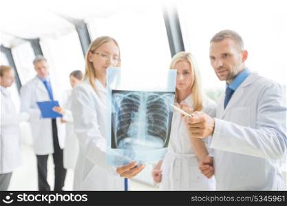 Group of doctors discuss x-ray. Group of doctors look and discuss x-ray in a clinic or hospital