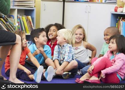 Group of Elementary Pupils In Classroom Listening To Teacher
