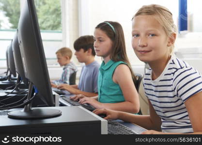 Group Of Elementary School Children In Computer Class