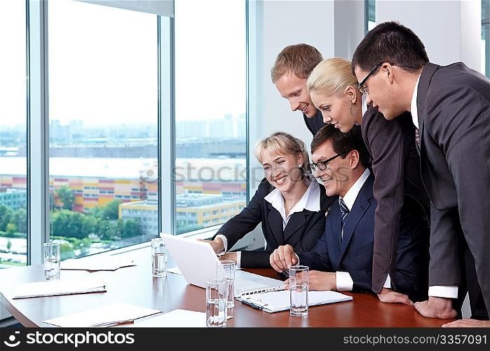 Group of employees in suits at office with the big window