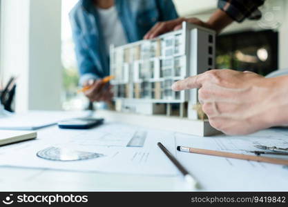 Group of engineer is discussion and brainstorming about condominium model of construction project.